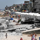 Illustration for article titled D-Day battle images merged with photos of tourists on the same spots